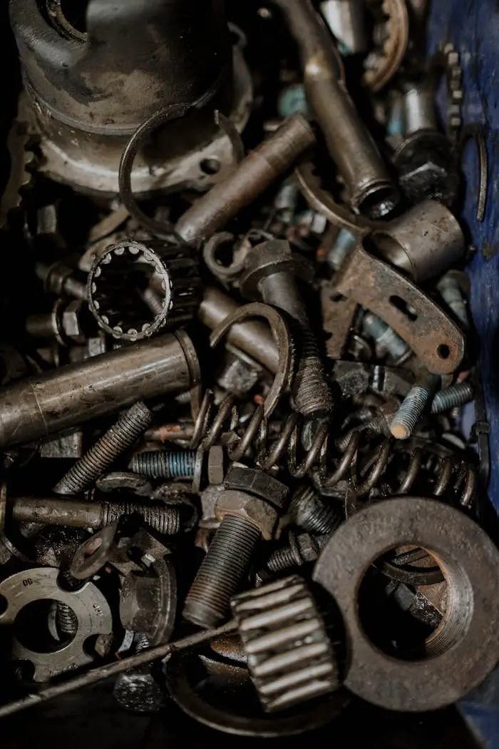A detailed close-up of various metal gears and spare parts, perfect for industrial themes.